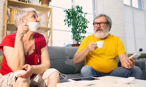 old couple having a conversation over tea