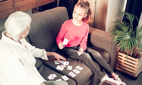 old lady and her granddaughter playing together