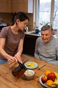 Parkinson's caregiver giving a nutritious meal to the patient